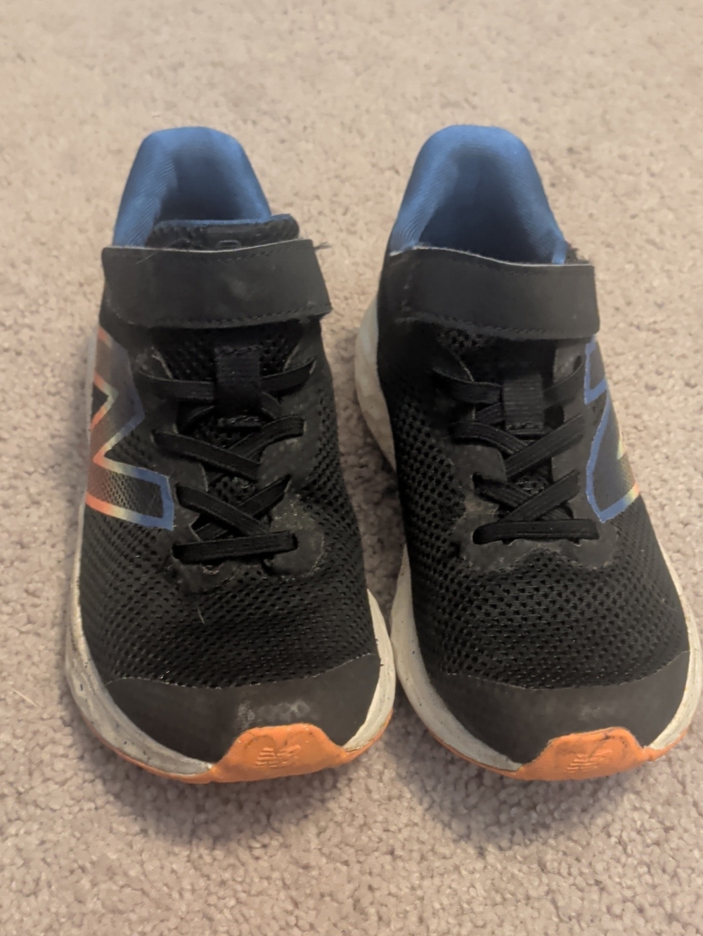 New Balance Kids Black Sneakers with Blue Lining and Orange Accents